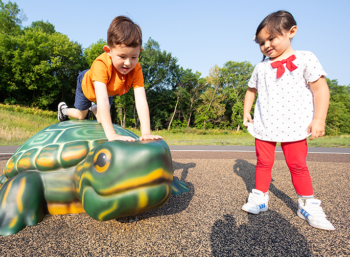 Children playing on Soft Play® turtle outdoors