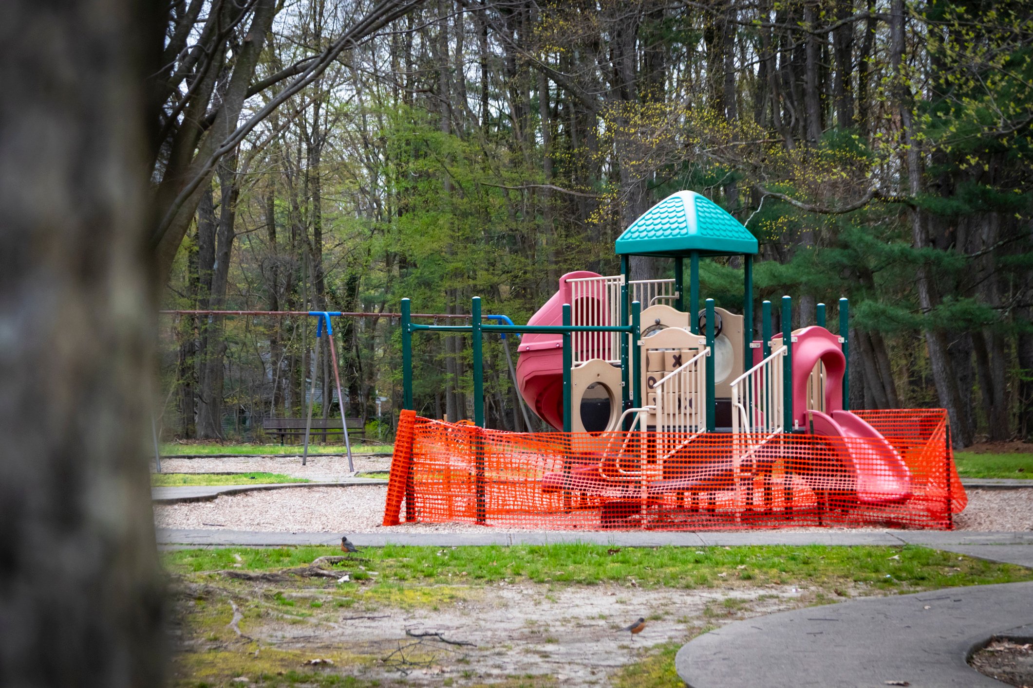 Shut down playground with orange mesh fencing