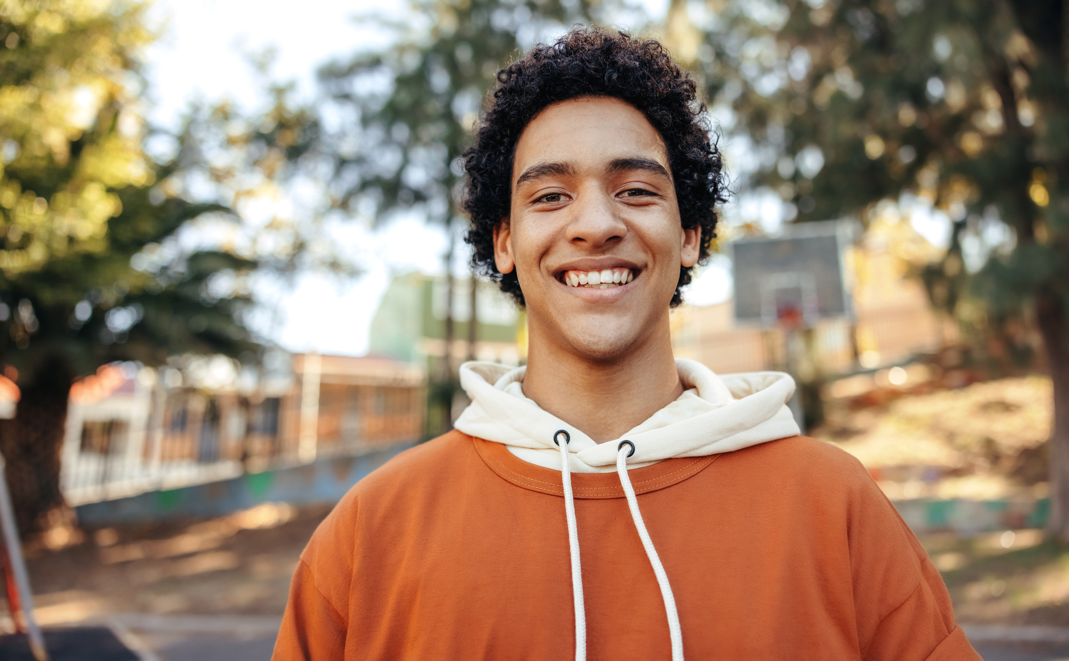 Teenage boy smiling outside